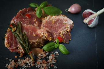 Raw pork neck meat with spices ready for barbeque