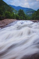 Obraz premium Putna waterfall in Romania and cloudy sky with rainbow