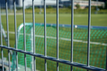 football or soccer pitch seen through fence