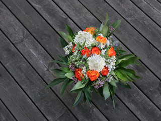 Fototapeta na wymiar Bouquet of orange Roses, Hydrangea, Aster and Oregano. Flowers from the garden.