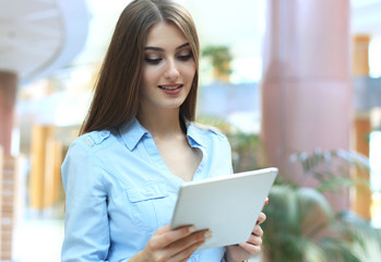 Young woman working with tablet in the office.