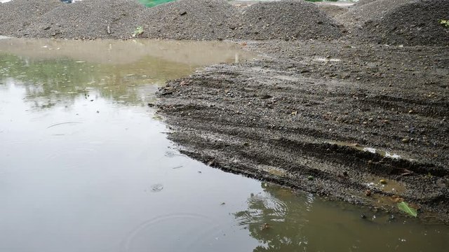 soil pile material in construction industry, rainy day scene