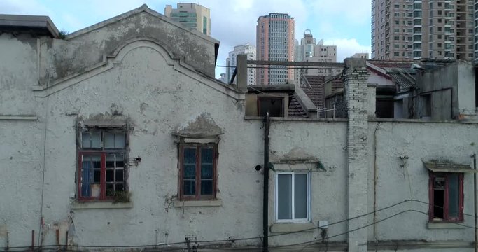 One of the very few remaining old Shanghai style residential areas shortly before its demolition, to make way for more high-rise development, such as those seen in the background. Part 1 of 3.