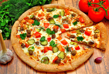 Pizza with meat, cucumbers, tomatoes and greens