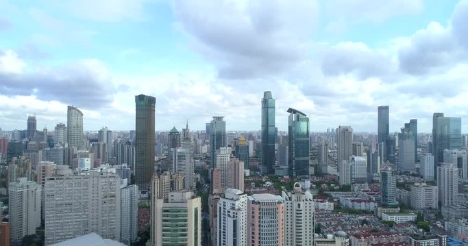 Ascending drone flight showing cityscape of modern megacity with highly populated build environment.  Jing'an District shown in the foreground is one of the central districts of Shanghai. 