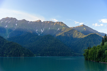 Fototapeta na wymiar Beautiful mountain Lake Ritsa. Lake Ritsa in the Caucasus Mountains, in the north-western part of Abkhazia, Georgia, surrounded by mixed mountain forests and subalpine meadows.