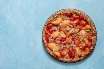 Homemade plum cake (pie) with crumble on light background. Summer fruit crumble pastry.