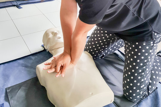 Cardiopulmonary resuscitation ( CPR ) training concept.Blur background woman student using hands doing heart pump in basic life saving and support course.