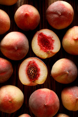 Fresh peaches on  black background, top view