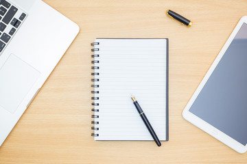 Flat lay photography. Empty notebook and a pen on a wooden table. Write memo office idea concept.