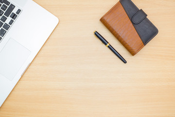 Flat lay photography. Empty notebook and a pen on a wooden table. Write memo office idea concept.