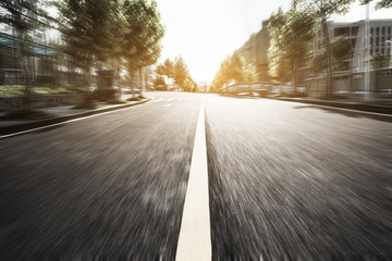 Asphalt road on college campus at sunset, motion blur