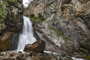 Nature stream waterfall in forest. Russia, Caucasus, Dombay, Shumka Falls