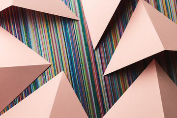Composition with triangular shapes of paper, colorful lines over background	