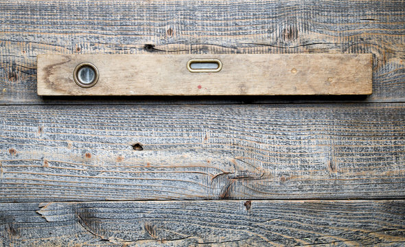 The old spirit level on wooden background