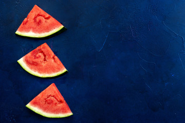 Fototapeta na wymiar Top view of watermelon slices on blue background