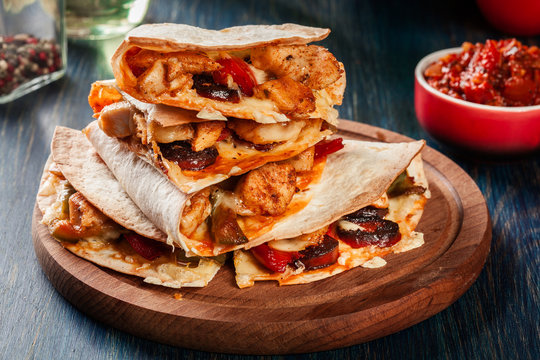 Stack of quesadillas with chicken, sausage chorizo and red peppe