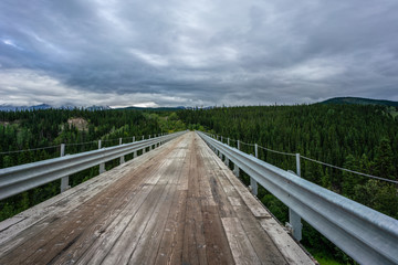 Fototapeta premium Bridge over Kuskulana river under the clouds