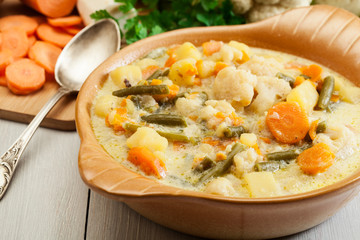 Vegetable soup with ingredients carrot, cauliflower, potato and