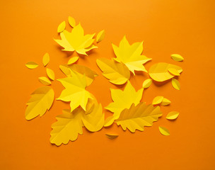 Autumn leaves made from paper orange background