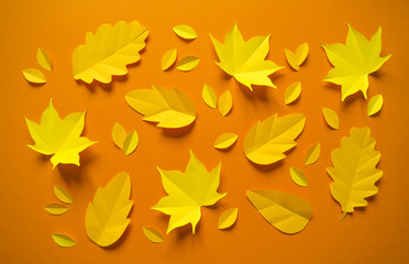 Naklejka na ściany i meble Autumn leaves made from paper orange background