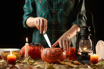 Fototapeta na wymiar Happy Halloween! Young woman preparing for Halloween in the kitchen. Beautiful woman with pumpkins.