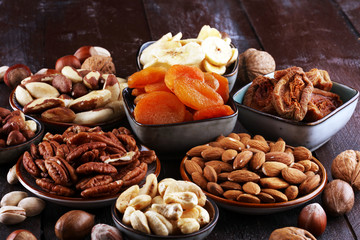 dried fruits and assorted nuts composition on rustic table
