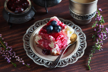 Piece of cake with jam and blueberries