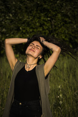 beautiful young girl in jacket lying down on grass