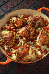 Free range chicken thighs with rice and honey glazed chantenay carrots in pan