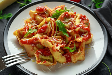 Spinach ricotta Ravioli in tomato sauce with wild rocket and parmesan cheese