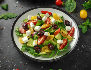 Fresh Greek salad with cucumber, cherry tomato, lettuce, red onion, feta cheese and black olives. Healthy food