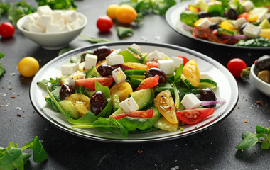 Fresh Greek salad with cucumber, cherry tomato, lettuce, red onion, feta cheese and black olives. Healthy food