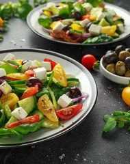 Fresh Greek salad with cucumber, cherry tomato, lettuce, red onion, feta cheese and black olives. Healthy food