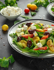 Fresh Greek salad with cucumber, cherry tomato, lettuce, red onion, feta cheese and black olives. Healthy food