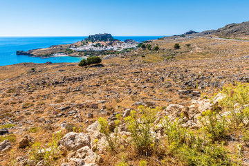 Fototapeta na wymiar View of the bay and the village of Lindos with the Acropolis on the hill.Rhodes, island, Greece