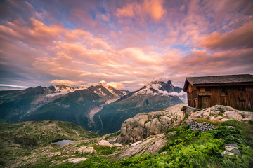 Cloudy Sunset over Iconic Mont-Blanc Range and Mountain Hut.