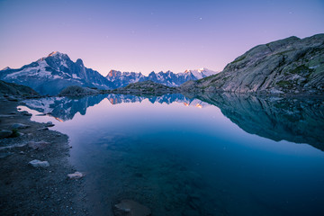 Fototapeta na wymiar Altitude Lake at Dawn Reflecting Starry Sky over Iconic Mont-Blanc Mountains