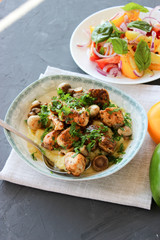 mashed potatoes with fried mushrooms and chicken on a side dish with tomatoes.