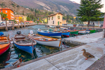 Fototapeta na wymiar Berth with boats in the town of Riva del Garda. Italy. Pier in Riva del Garda.