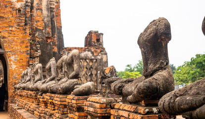 Fototapeta na wymiar Old headless mediating buddha statues located in Wat Chaiwatthanaram which is part of Ayutthaya Historical Park.