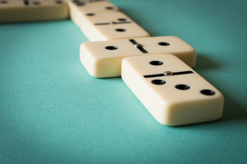Playing dominoes on a light background . The concept of the game of dominoes. Close up