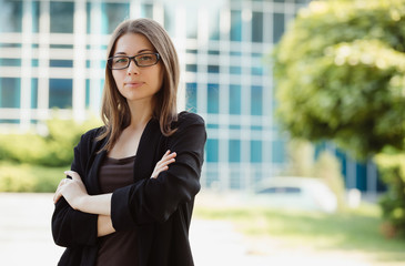 Confident businesswoman portrait near office building