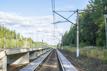 A view at the and railroad sleepers going through the forest