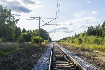 A view at the and railroad sleepers going through the forest