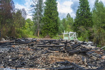 Ruins of a building after a fire in the forest / Burned house concept