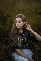 Beautiful Young Woman in a field evening