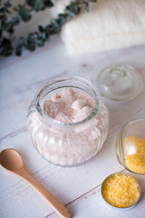 pink and yellow bath salt on white wooden table