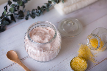 pink and yellow bath salt on white wooden table