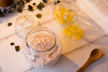 pink and yellow bath salt on white wooden table
